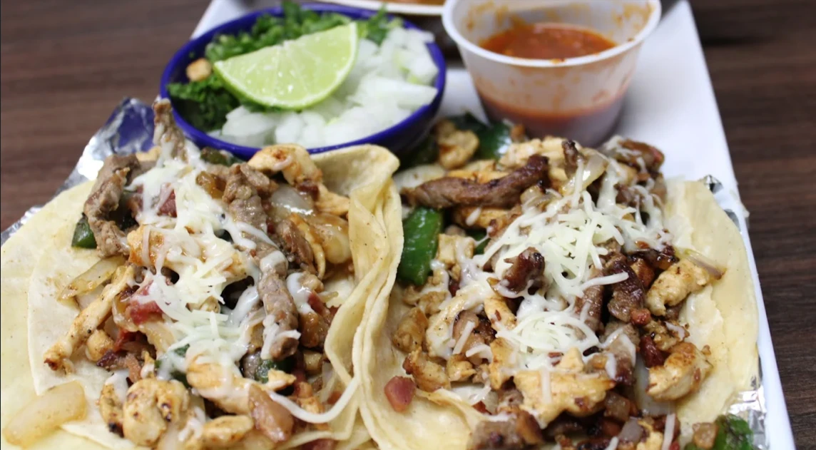 Steak and chicken street tacos with onion, cilantro and lime from La Fiesta.